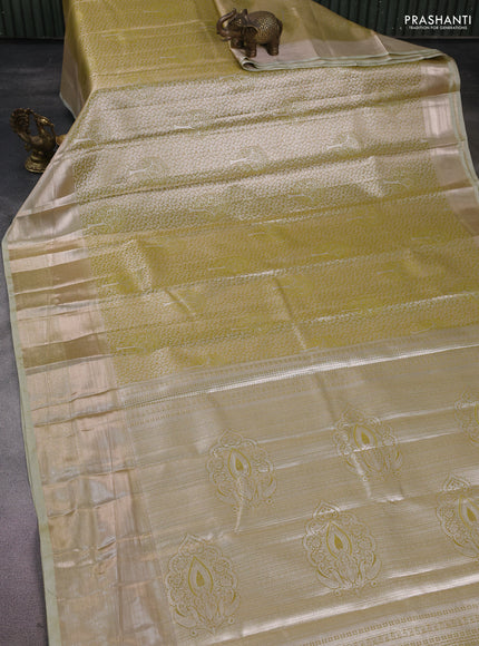 Semi kanchipuram tissue silk saree lime green and elaichi green with allover silver zari woven brocade weaves and long zari woven border