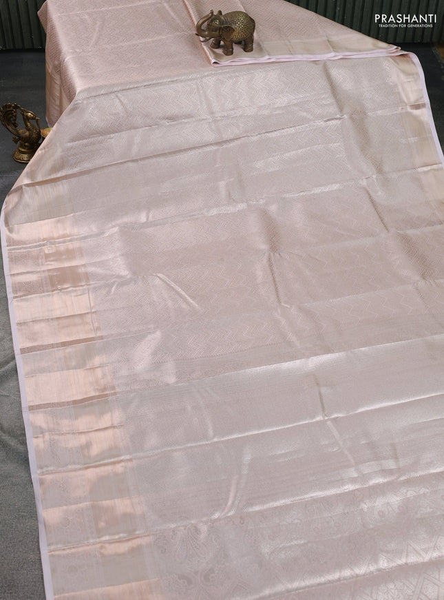 Semi kanchipuram tissue silk saree pastel peach with allover silver zari woven brocade weaves and long zari woven border