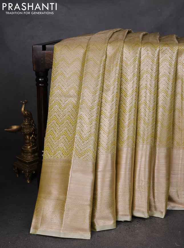 Semi kanchipuram tissue silk saree elaichi green with allover silver zari woven brocade weaves and long zari woven border