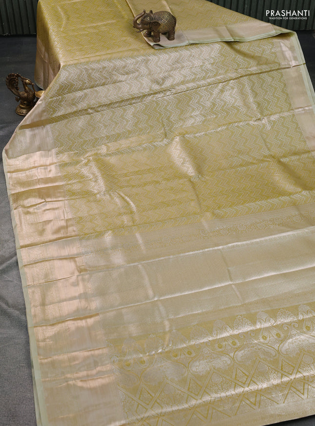Semi kanchipuram tissue silk saree elaichi green with allover silver zari woven brocade weaves and long zari woven border