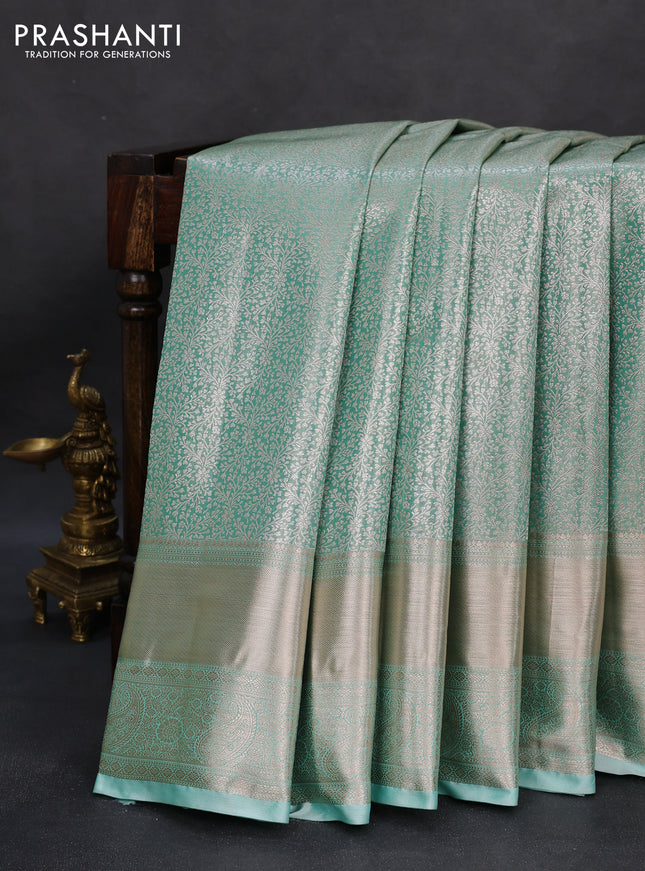 Semi kanchipuram tissue silk saree teal blue with allover silver zari woven brocade weaves and long zari woven border