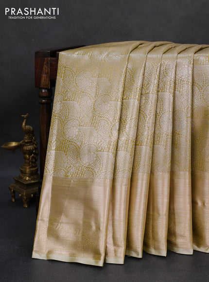 Semi kanchipuram tissue silk saree elaichi green with allover silver zari woven brocade weaves and long zari woven border