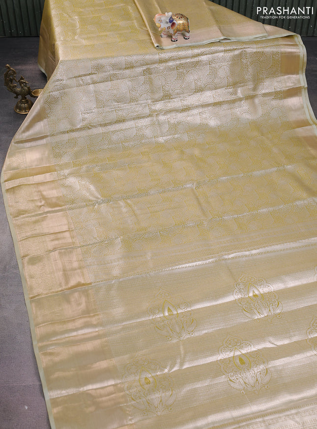 Semi kanchipuram tissue silk saree elaichi green with allover silver zari woven brocade weaves and long zari woven border