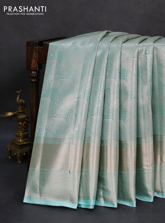 Semi kanchipuram tissue silk saree teal blue with allover silver zari woven brocade weaves and long zari woven border