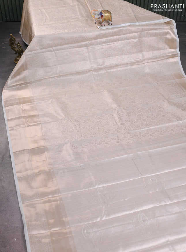 Semi kanchipuram tissue silk saree cream with allover silver zari woven brocade weaves and long zari woven border