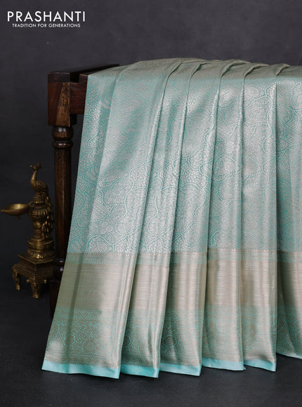 Semi kanchipuram tissue silk saree teal shade with allover silver zari woven brocade weaves and long zari woven border