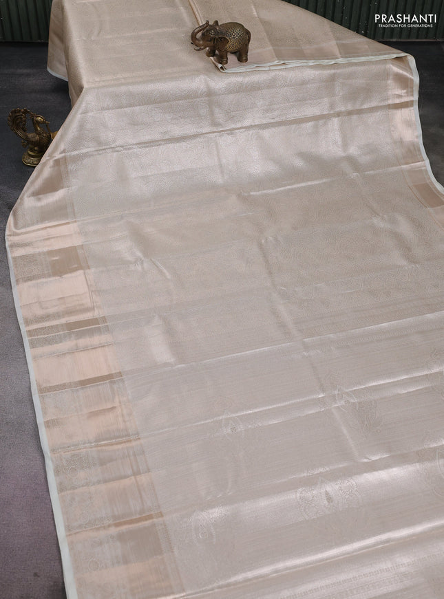 Semi kanchipuram tissue silk saree cream with allover silver zari woven brocade weaves and long zari woven border