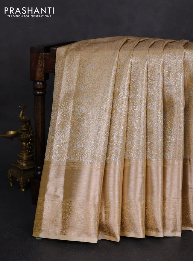 Semi kanchipuram tissue silk saree sandal with allover silver zari woven brocade weaves and long zari woven border