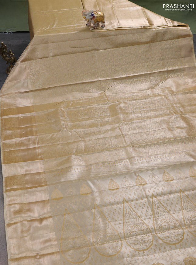 Semi kanchipuram tissue silk saree sandal with allover silver zari woven brocade weaves and long zari woven border