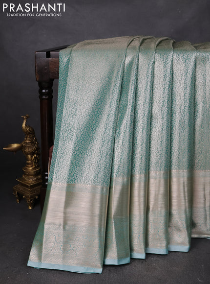 Semi kanchipuram tissue silk saree teal with allover silver zari woven brocade weaves and long zari woven border