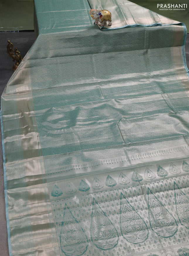 Semi kanchipuram tissue silk saree teal with allover silver zari woven brocade weaves and long zari woven border