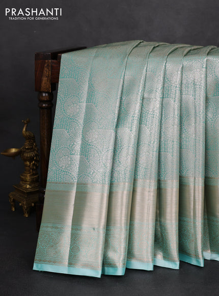 Semi kanchipuram tissue silk saree teal blue with allover silver zari woven brocade weaves and long zari woven border