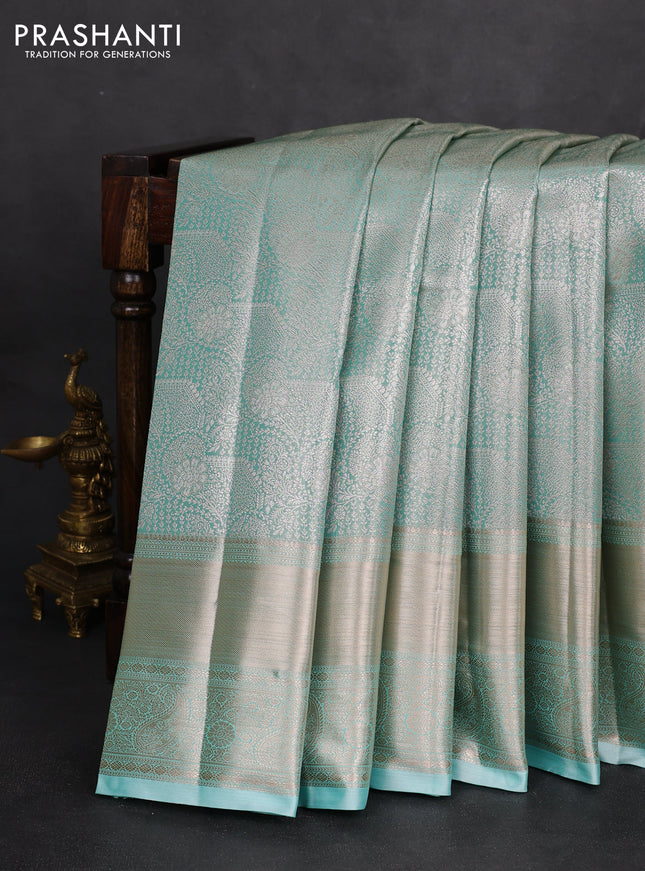 Semi kanchipuram tissue silk saree teal blue with allover silver zari woven brocade weaves and long zari woven border