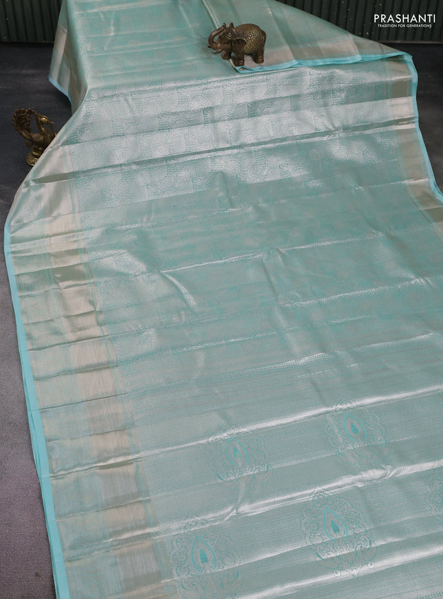 Semi kanchipuram tissue silk saree teal blue with allover silver zari woven brocade weaves and long zari woven border