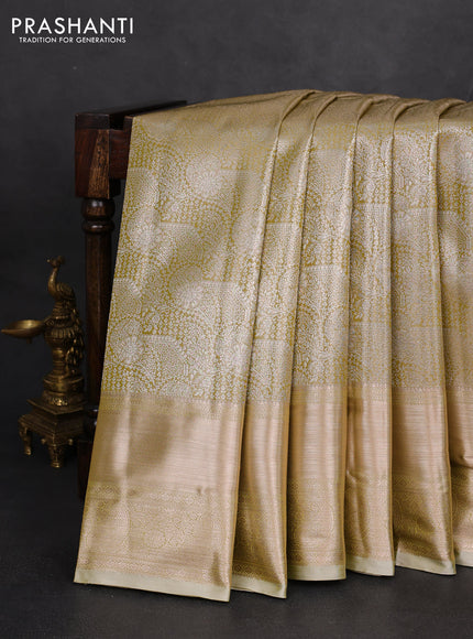Semi kanchipuram tissue silk saree lime green shade and elaichi green with allover silver zari woven brocade weaves and long zari woven border