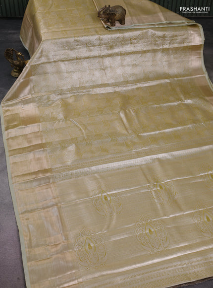 Semi kanchipuram tissue silk saree lime green shade and elaichi green with allover silver zari woven brocade weaves and long zari woven border