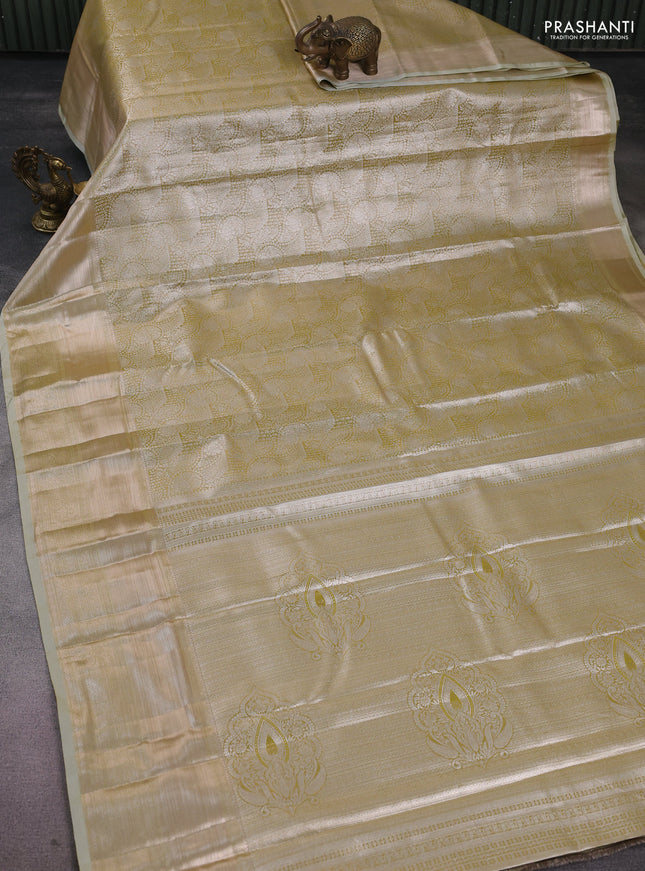 Semi kanchipuram tissue silk saree lime green shade and elaichi green with allover silver zari woven brocade weaves and long zari woven border