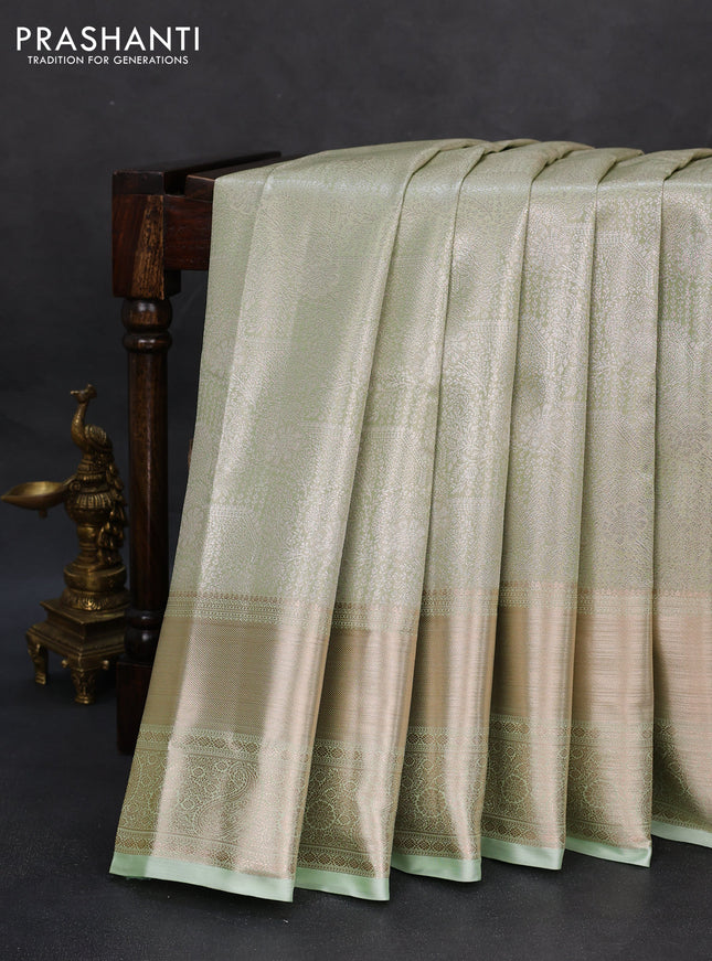 Semi kanchipuram tissue silk saree pista green with allover silver zari woven brocade weaves and long zari woven border