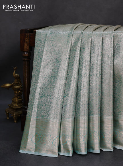 Semi kanchipuram tissue silk saree teal shade with allover silver zari woven brocade weaves and zari woven border