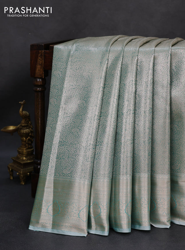 Semi kanchipuram tissue silk saree teal shade with allover silver zari woven brocade weaves and zari woven border