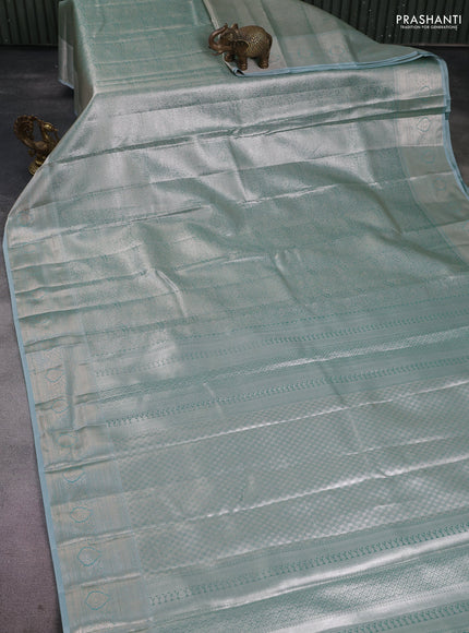 Semi kanchipuram tissue silk saree teal shade with allover silver zari woven brocade weaves and zari woven border