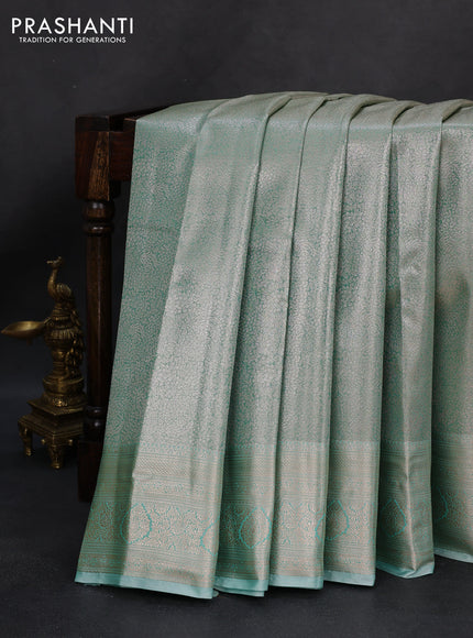 Semi kanchipuram tissue silk saree teal shade with allover silver zari woven brocade weaves and zari woven border