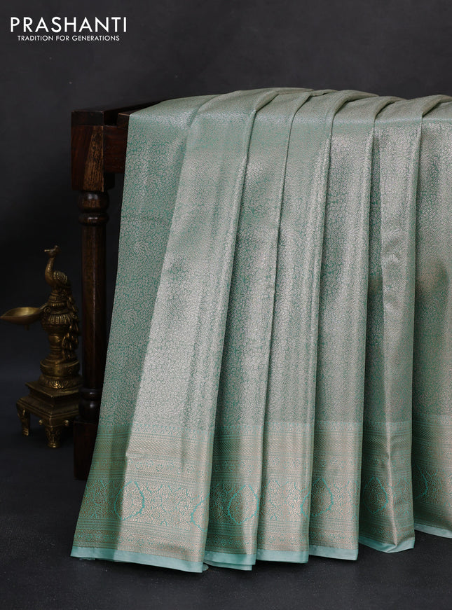 Semi kanchipuram tissue silk saree teal shade with allover silver zari woven brocade weaves and zari woven border
