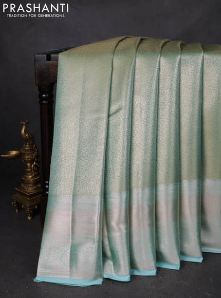 Semi kanchipuram tissue silk saree teal shade with allover silver zari woven brocade weaves and long zari woven border