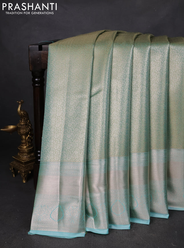 Semi kanchipuram tissue silk saree teal shade with allover silver zari woven brocade weaves and long zari woven border