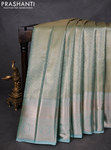 Semi kanchipuram tissue silk saree dual shade of green and teal with allover silver zari woven brocade weaves and long zari woven border