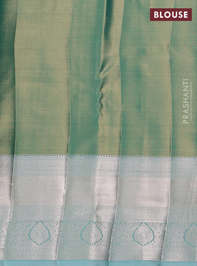 Semi kanchipuram tissue silk saree dual shade of green and teal with allover silver zari woven brocade weaves and long zari woven border