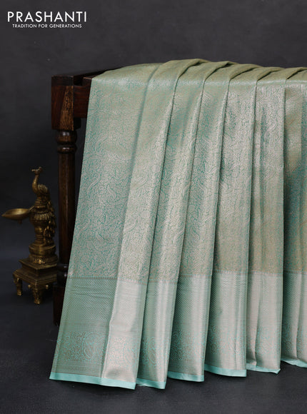 Semi kanchipuram tissue silk saree dual shade of teal with allover silver zari woven brocade weaves and zari woven border