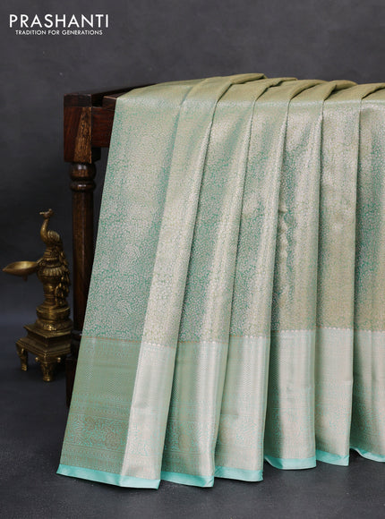 Semi kanchipuram tissue silk saree dual shade of teal with allover silver zari woven brocade weaves and long zari woven border