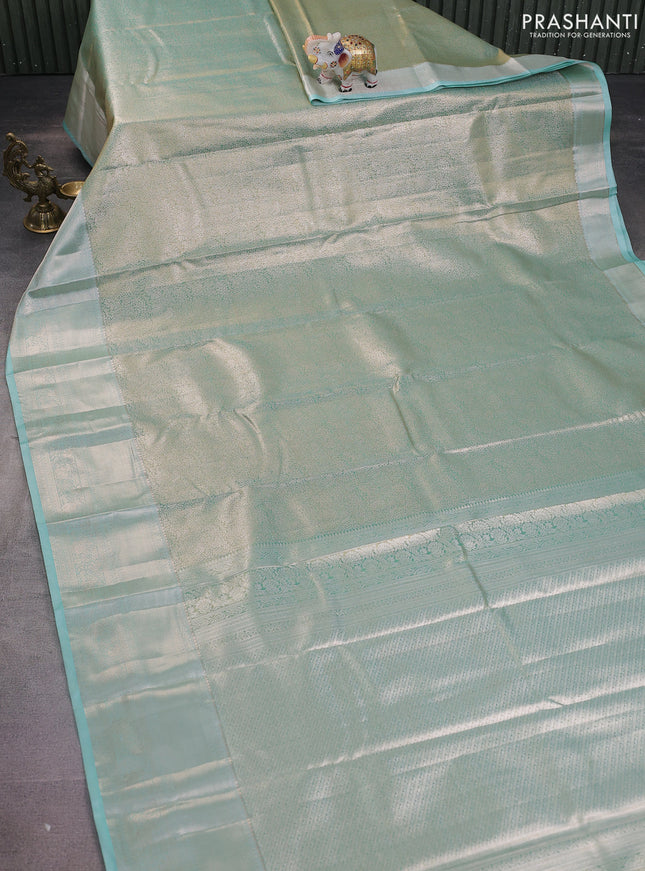 Semi kanchipuram tissue silk saree dual shade of teal with allover silver zari woven brocade weaves and long zari woven border