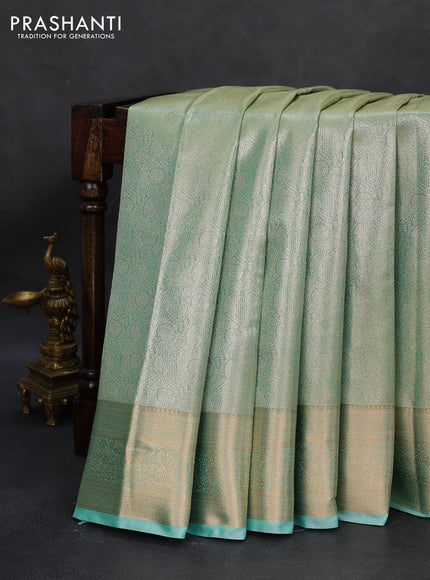 Semi kanchipuram tissue silk saree teal shade with allover silver zari woven brocade weaves and rich zari woven border