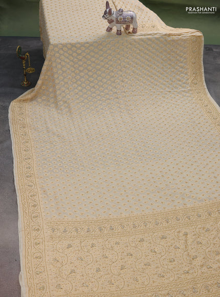 Banarasi georgette saree cream with woven buttas & stone work and zardosi work border