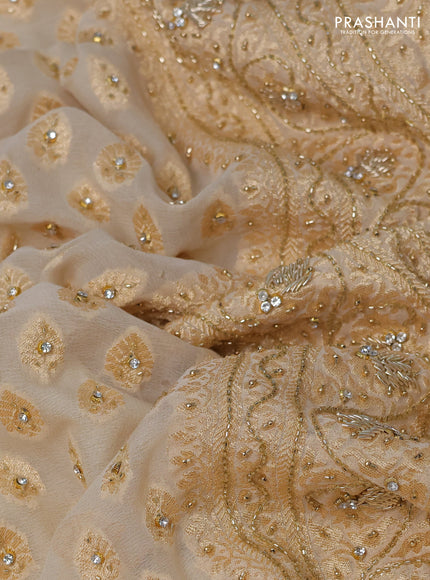 Banarasi georgette saree cream with woven buttas & stone work and zardosi work border