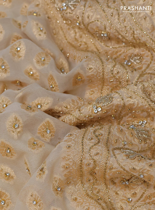 Banarasi georgette saree cream with woven buttas & stone work and zardosi work border