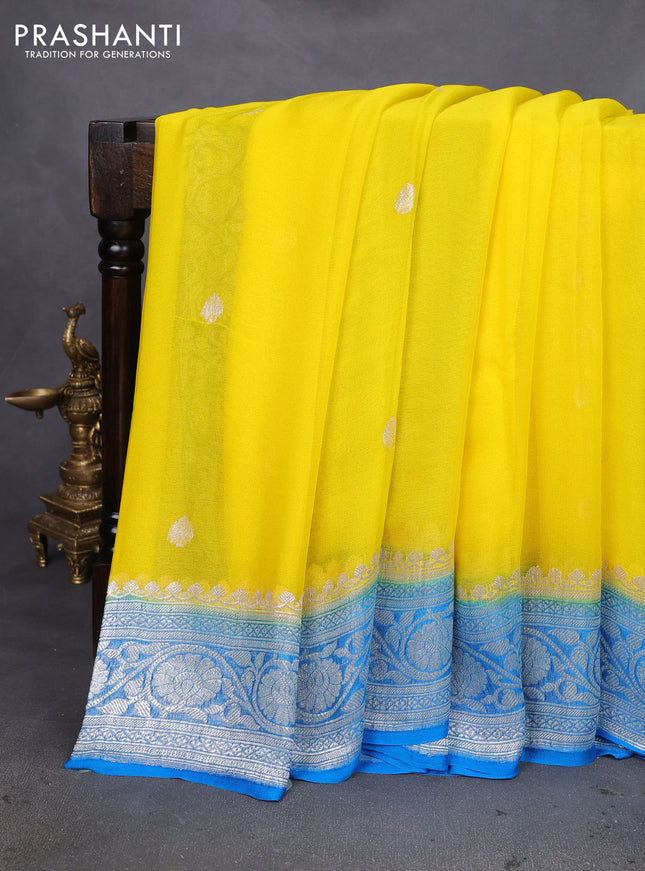 Banarasi chiffon silk saree yellow and cs blue with silver zari woven buttas and silver zari woven floral border