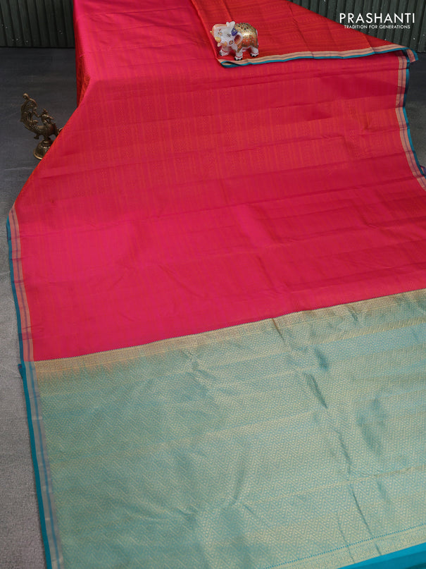 Pure kanchipuram silk saree dual shade of pinkish orange and teal green with allover self emboss and zari woven border