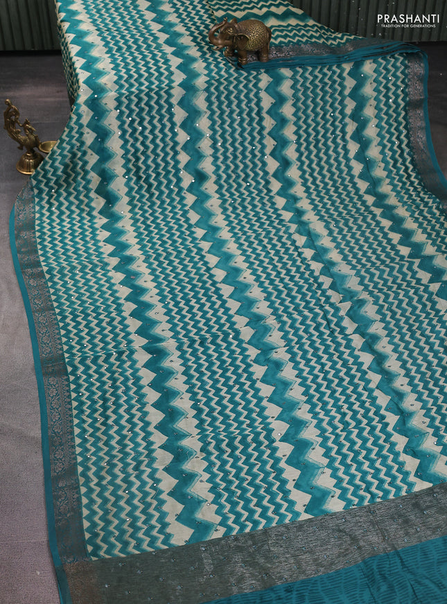 Chanderi silk cotton saree teal green and cream with allover zig zag weaves & mirror work and zari woven border