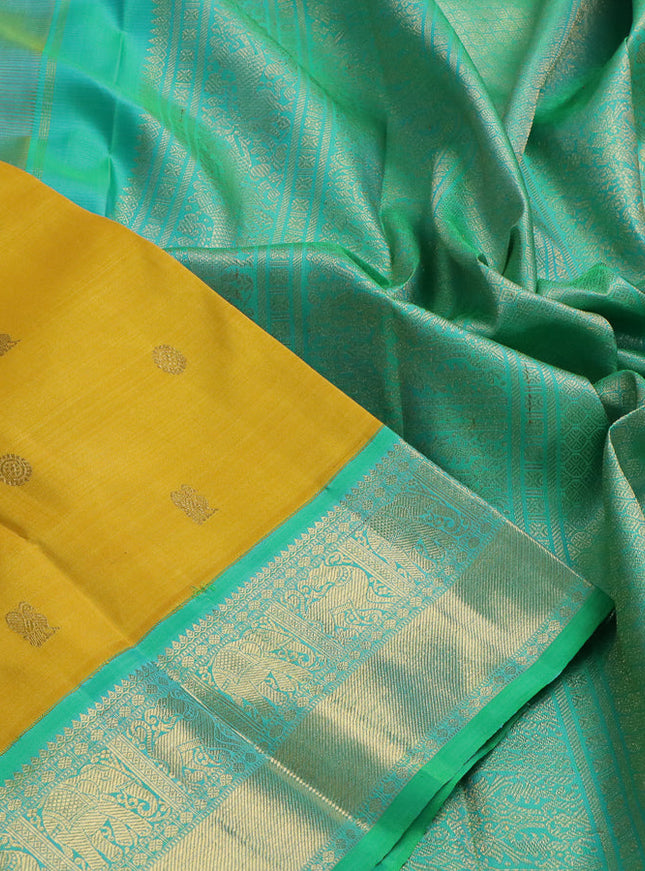 Pure kanchipuram silk saree mustard yellow and green with zari woven buttas and zari woven korvai border