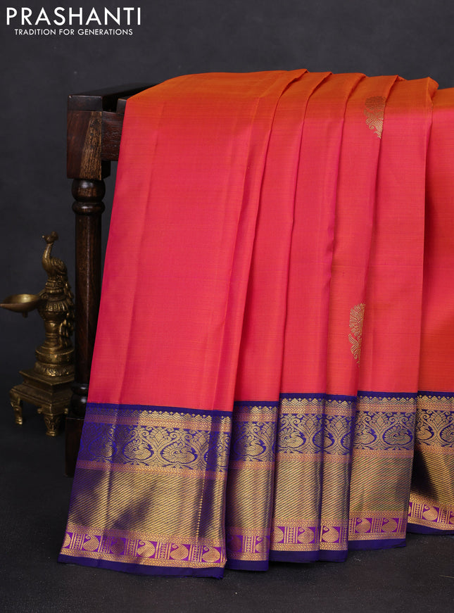 Pure kanchipuram silk saree dual shade of pinkish orange and blue with annam zari woven buttas and zari woven korvai border