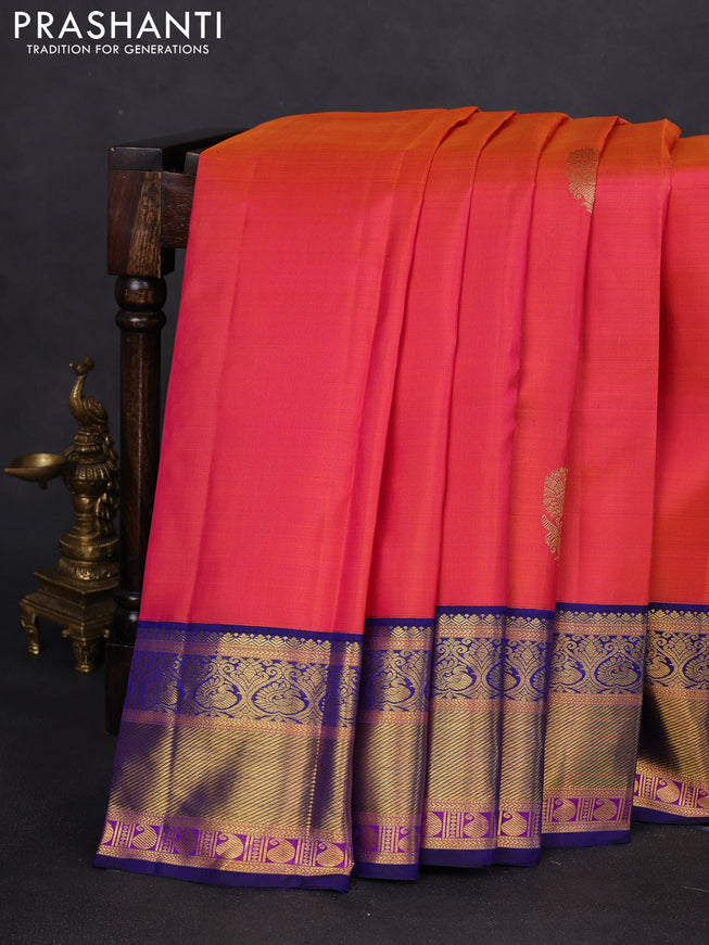 Pure kanchipuram silk saree dual shade of pinkish orange and blue with annam zari woven buttas and zari woven korvai border