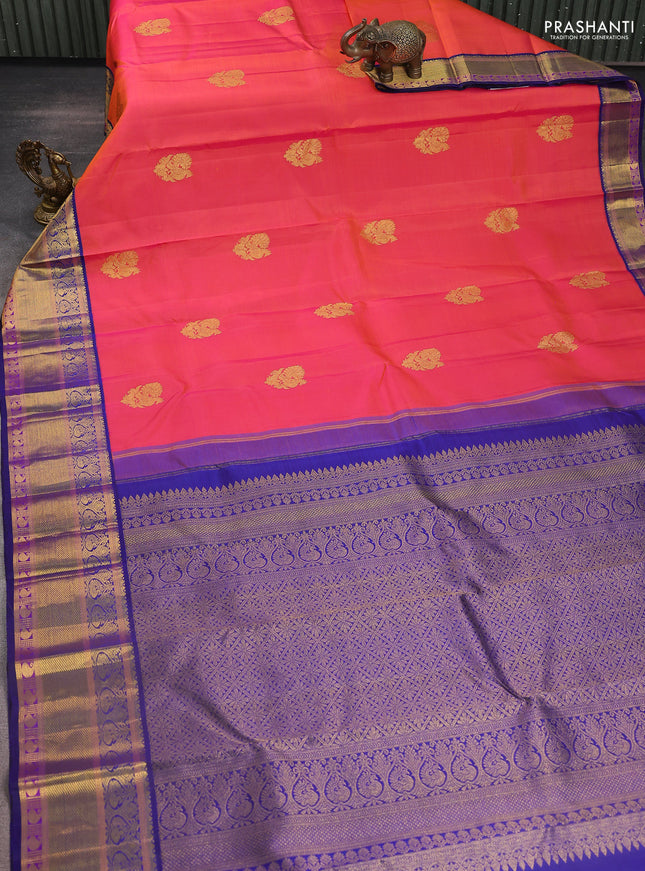 Pure kanchipuram silk saree dual shade of pinkish orange and blue with annam zari woven buttas and zari woven korvai border