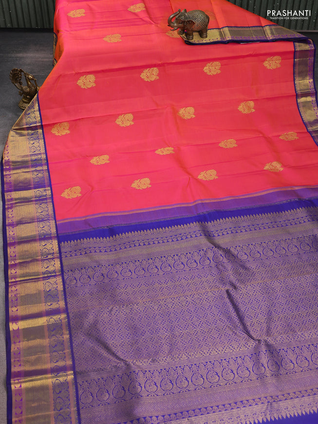 Pure kanchipuram silk saree dual shade of pinkish orange and blue with annam zari woven buttas and zari woven korvai border