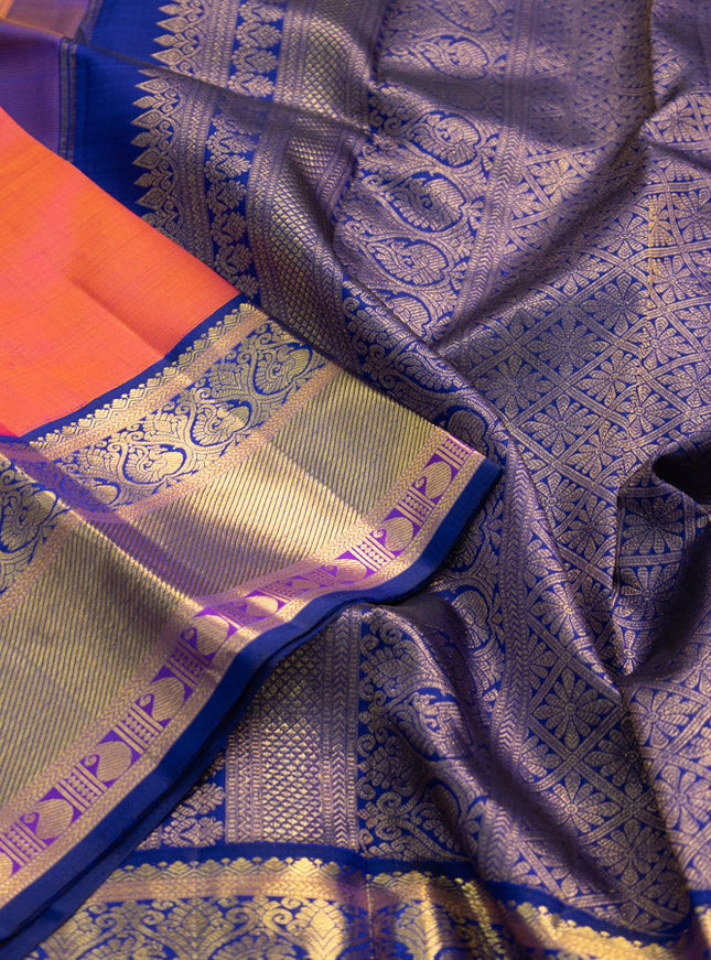 Pure kanchipuram silk saree dual shade of pinkish orange and blue with annam zari woven buttas and zari woven korvai border