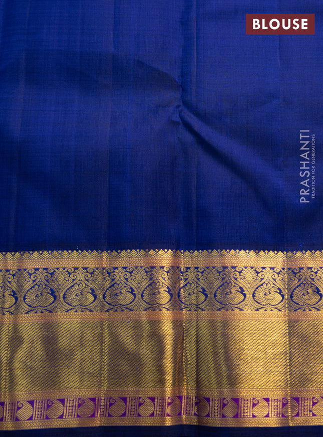 Pure kanchipuram silk saree dual shade of pinkish orange and blue with annam zari woven buttas and zari woven korvai border