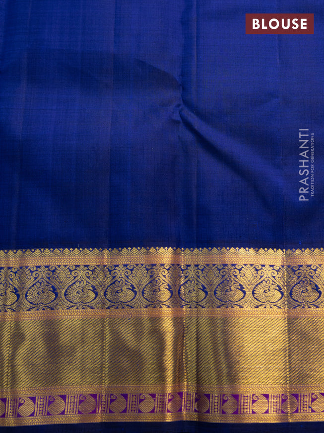 Pure kanchipuram silk saree dual shade of pinkish orange and blue with annam zari woven buttas and zari woven korvai border
