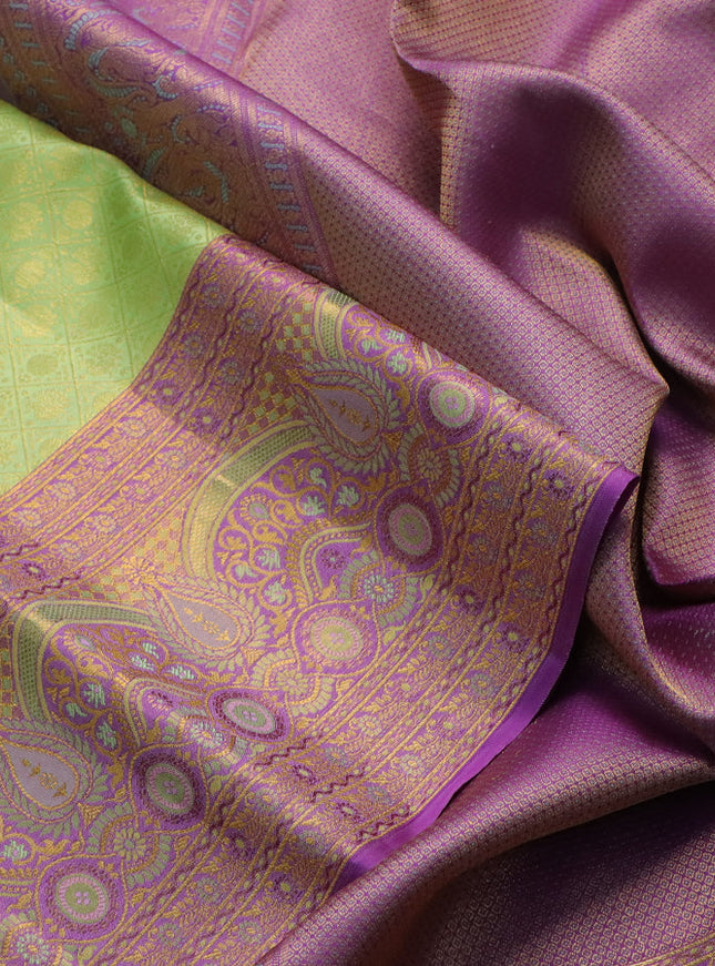 Pure kanchipuram silk saree pista green and purple with allover zari woven brocade weaves and zari woven mina border